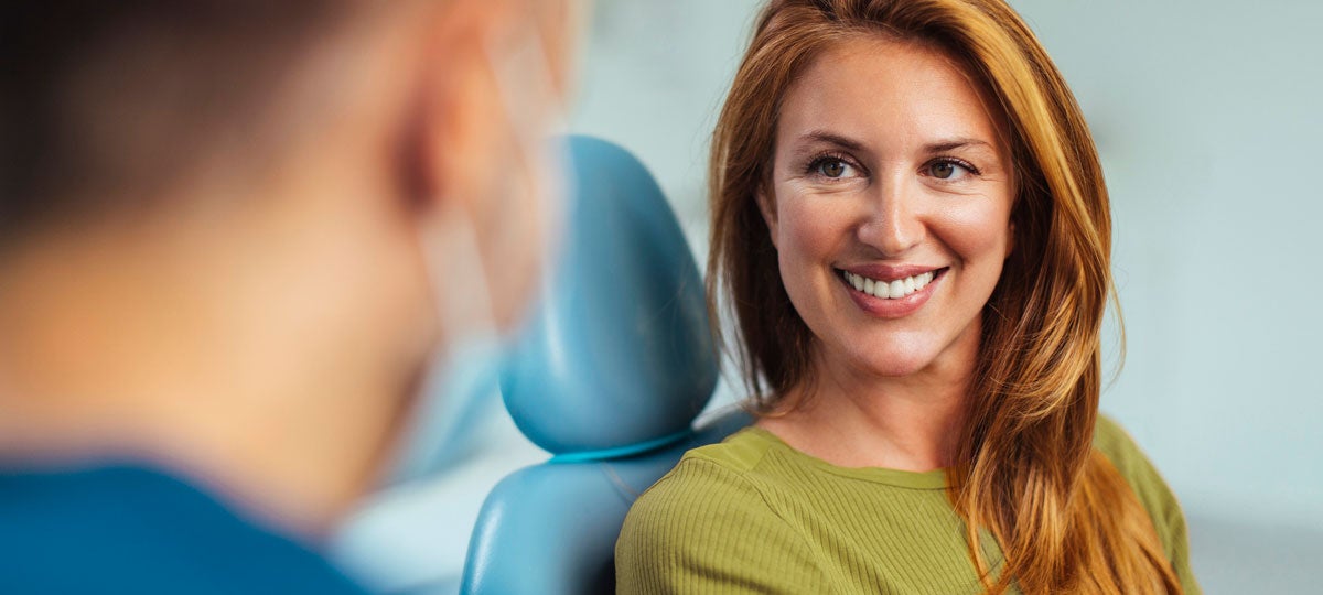 A woman smiling at a dentist