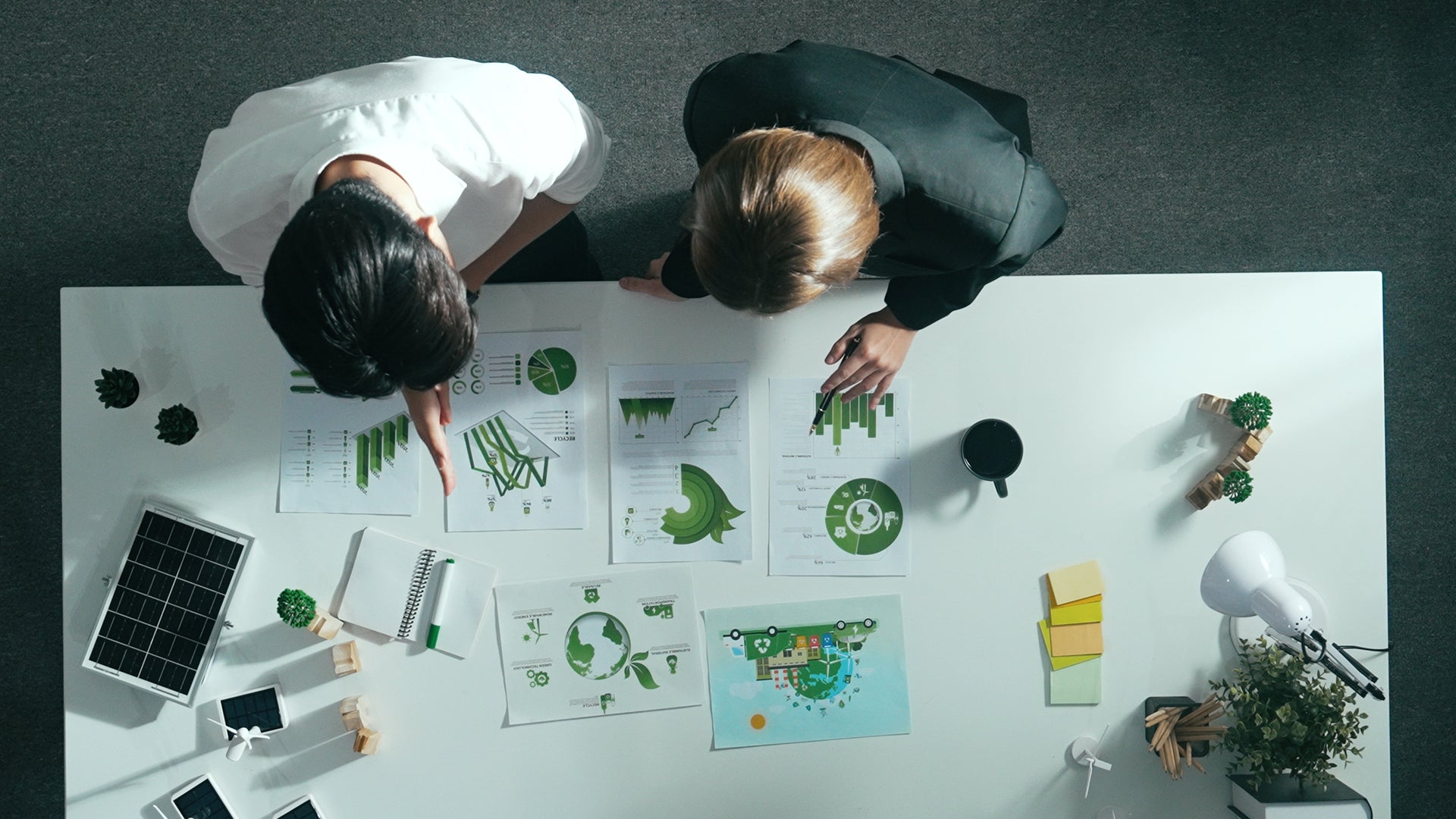 Employees at work looking at plans on the table