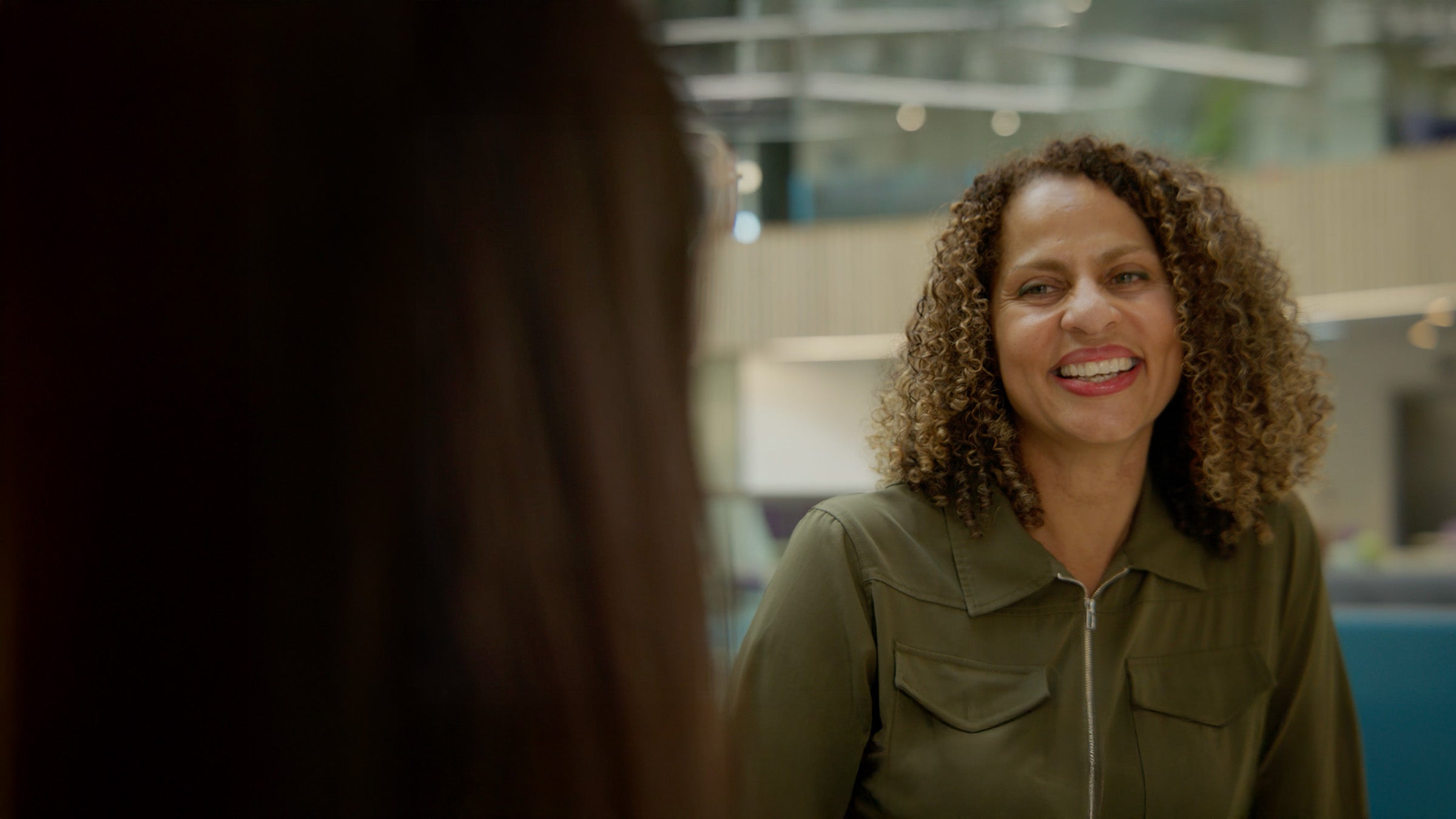 A woman smiling at another woman
