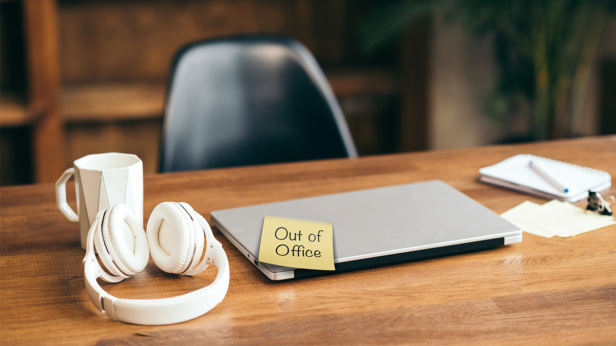 A laptop and headphones on a table