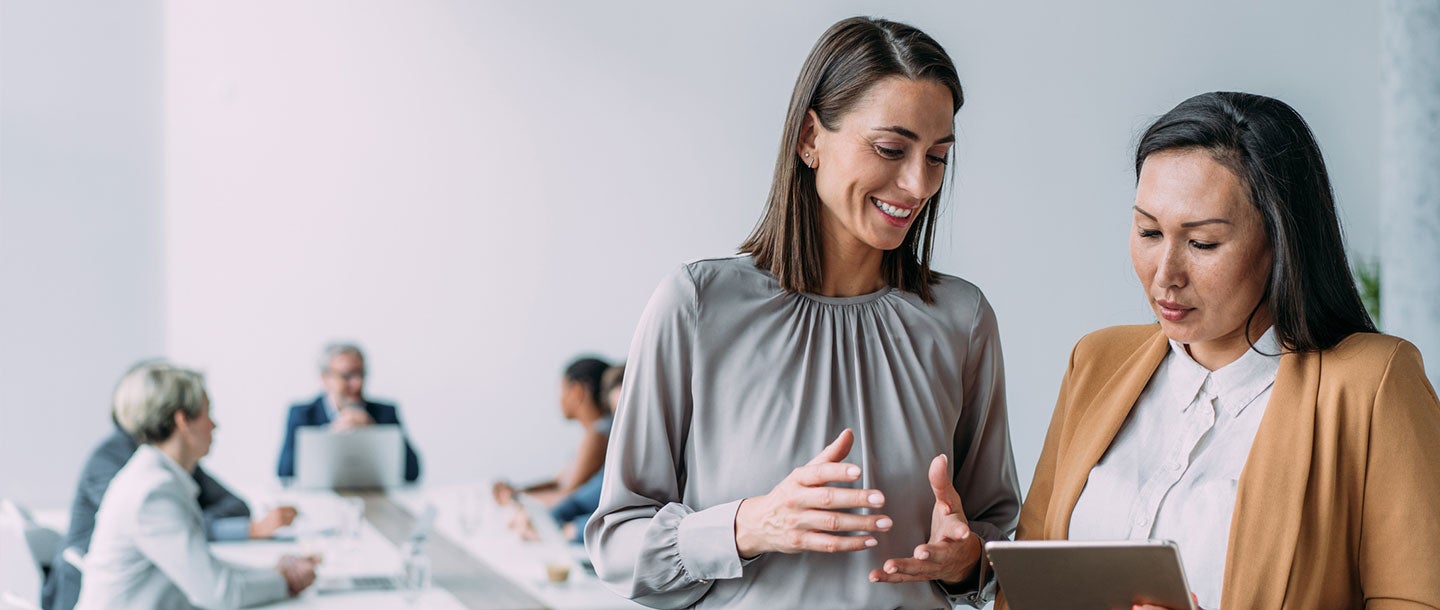 Employer speaking with an employee in the office