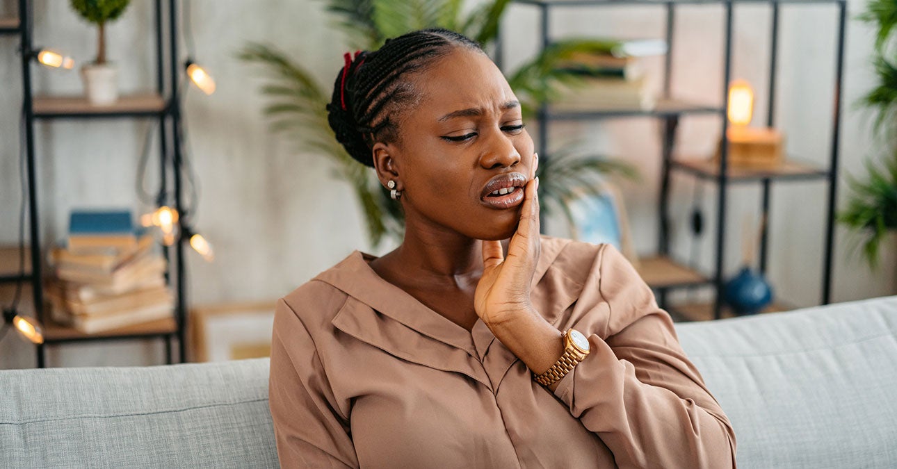 A woman with her hand on her cheek