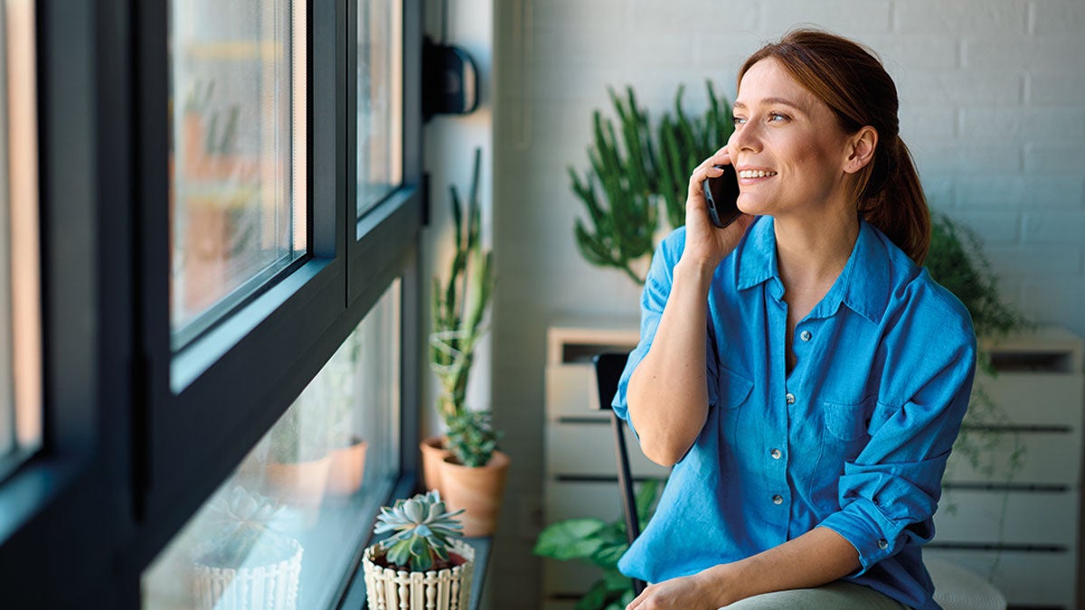 Lady sat by window on the phone