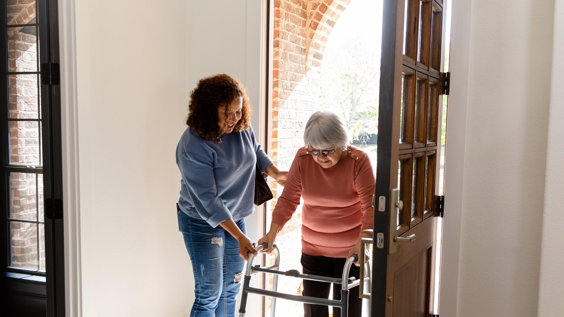 Carer helping elder person