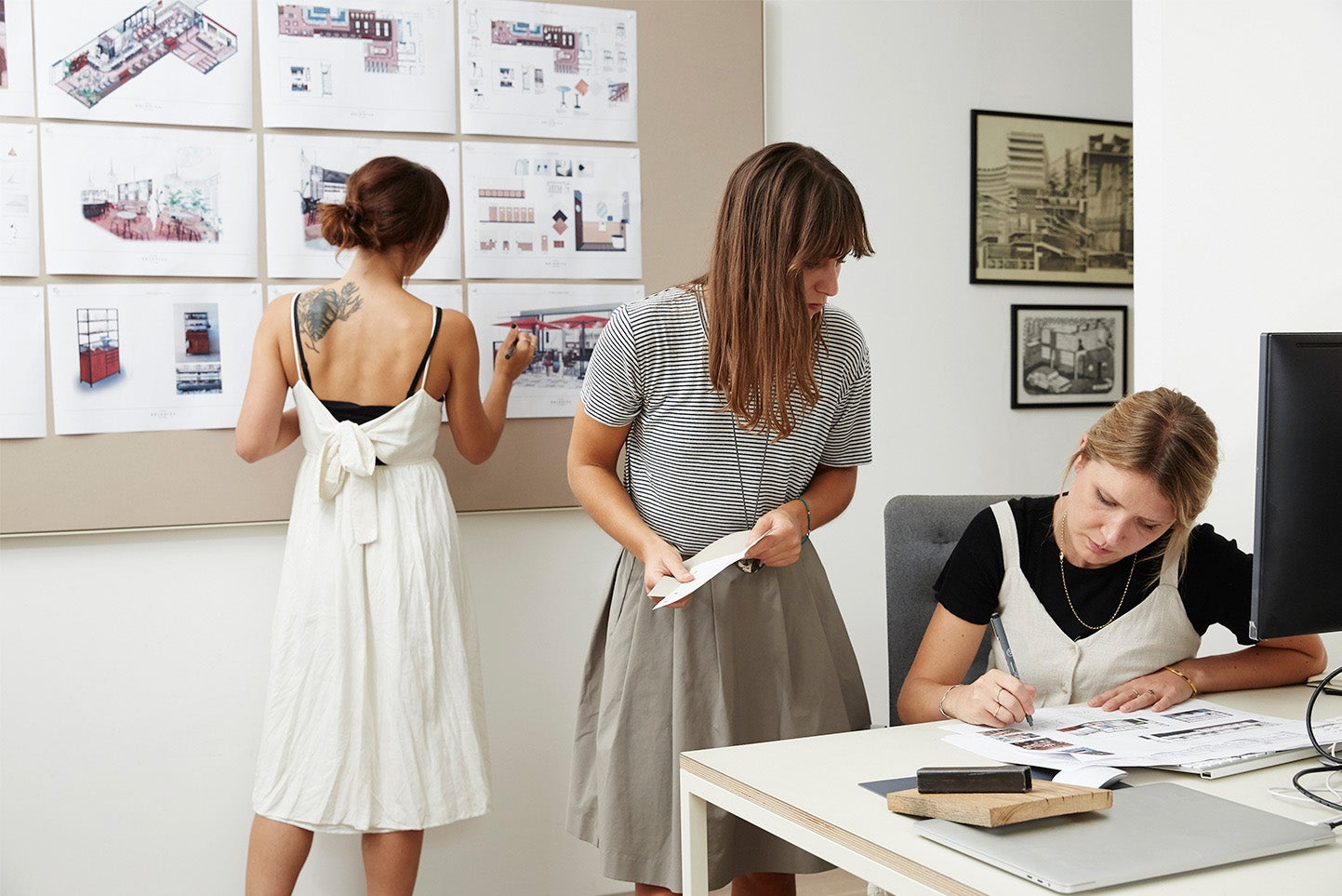 Three woman working in office of an interior design small business