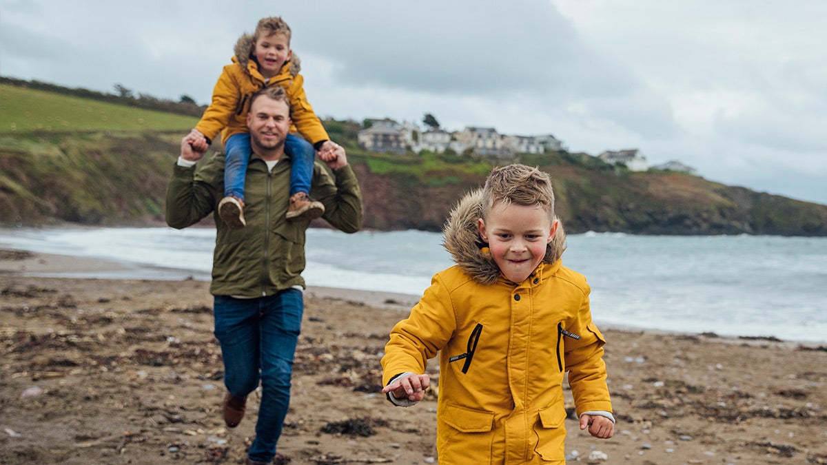 Father and children on the beach