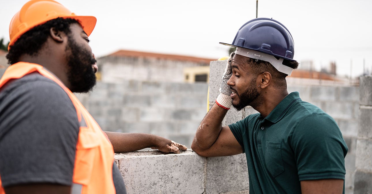 Two construction workers having a conversation