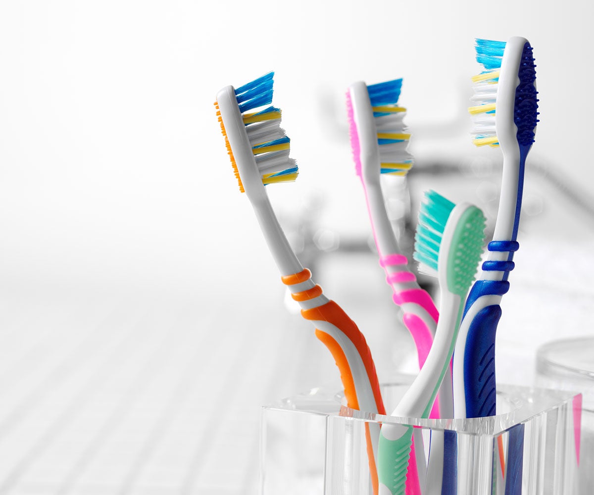 Colourful toothbrushes in a cup