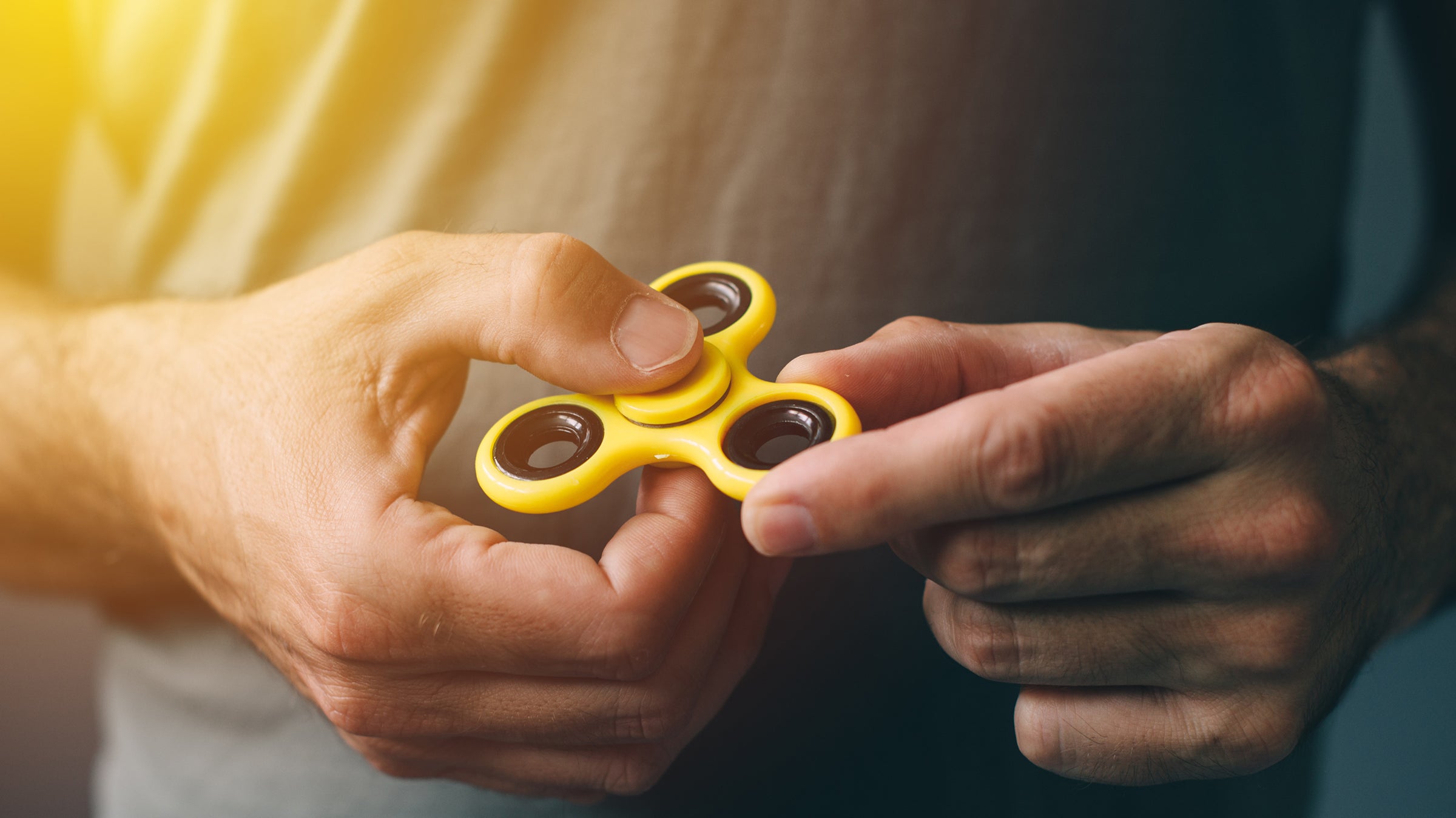Person holding a spinner toy