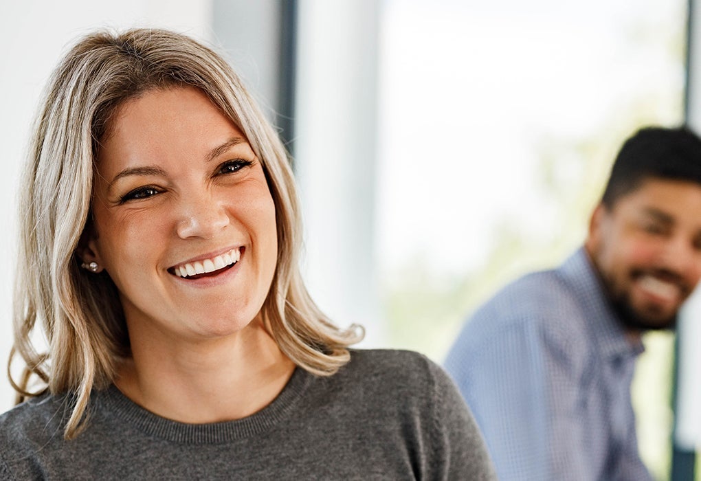 Smiling woman in grey jumper