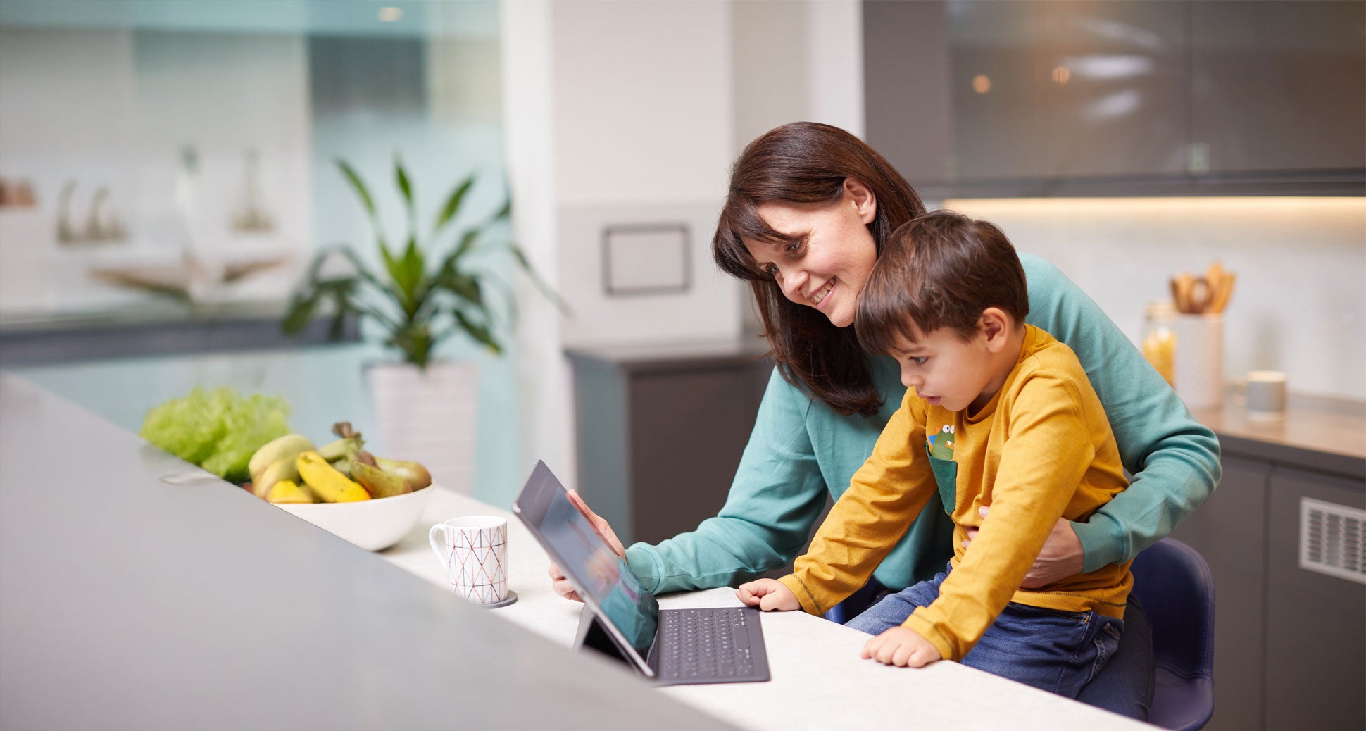 A woman and a child looking at a tablet