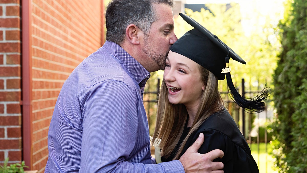 Proud father celebrating daughters graduation
