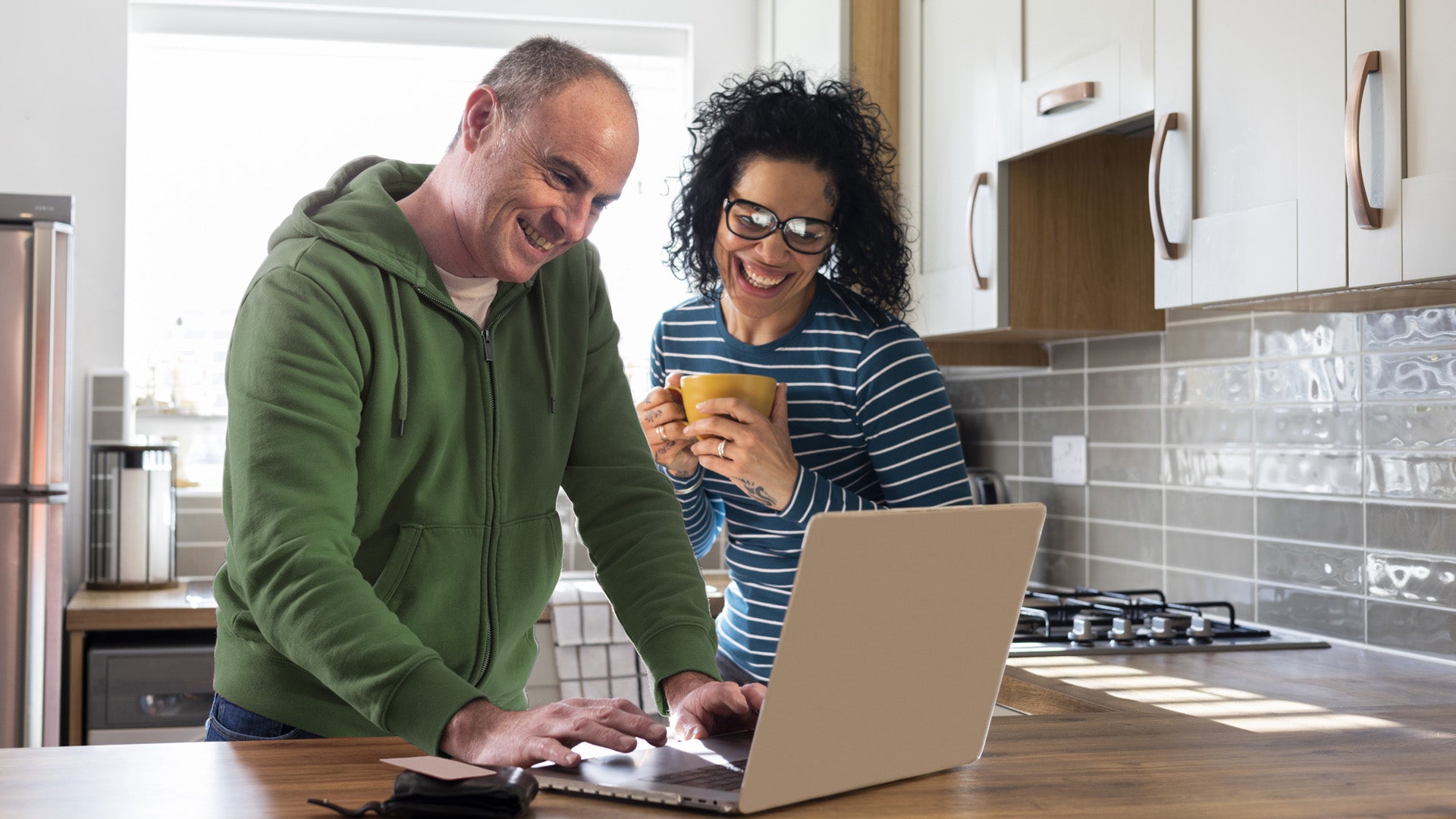 A man and woman looking at a laptop