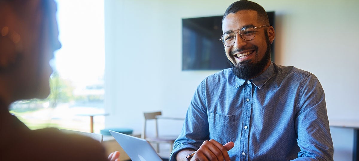 Smiling employee talking to a colleague