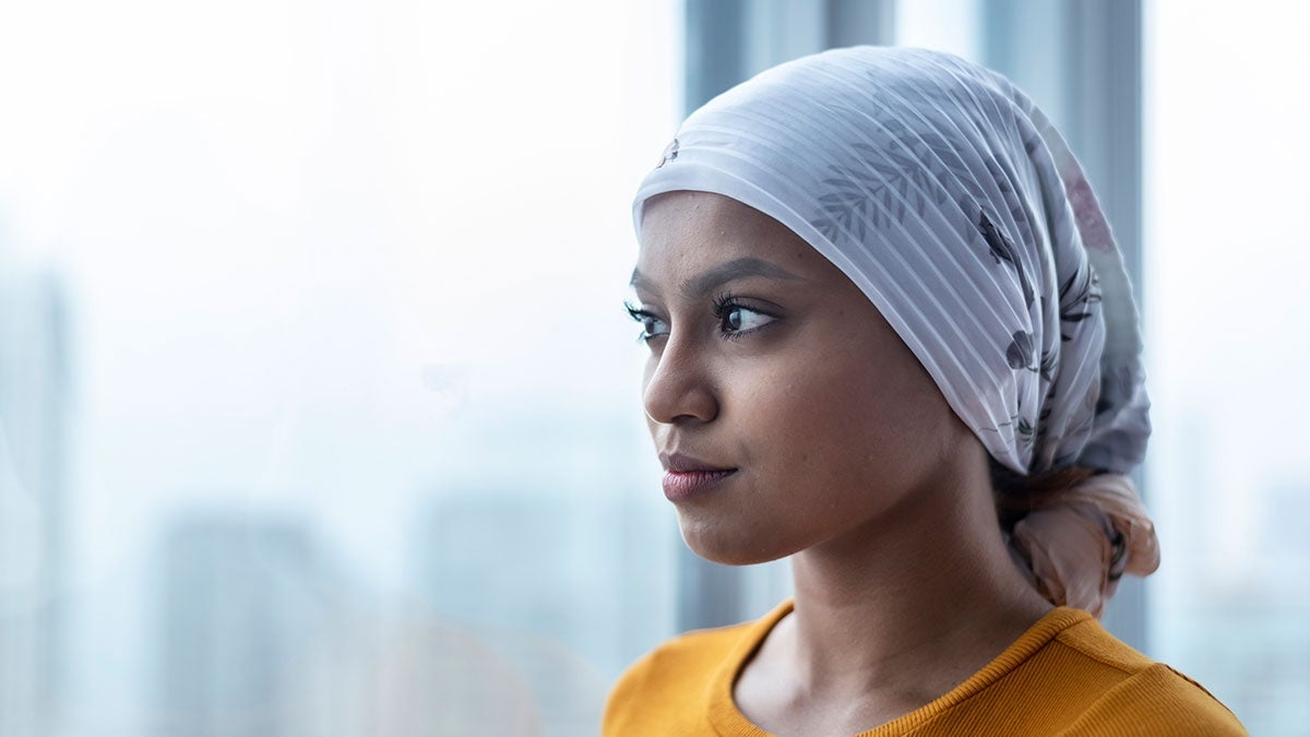 A woman wearing a white head scarf