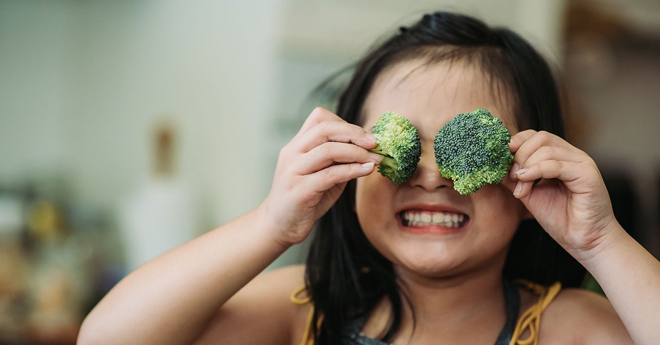 Girl holding broccoli