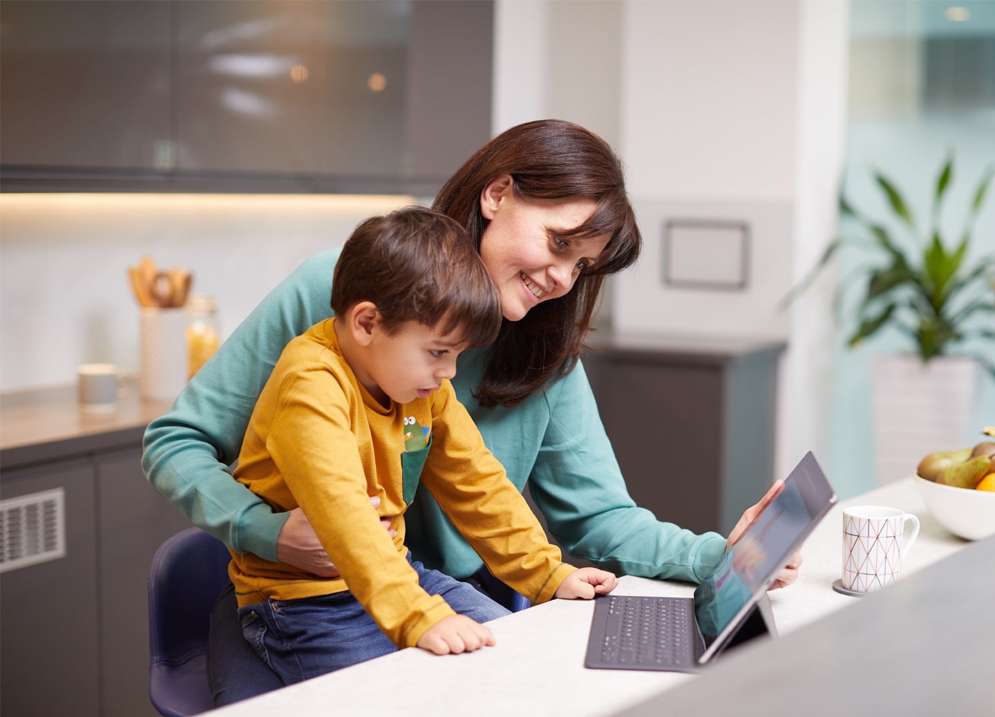 Mum and son watching on a computer