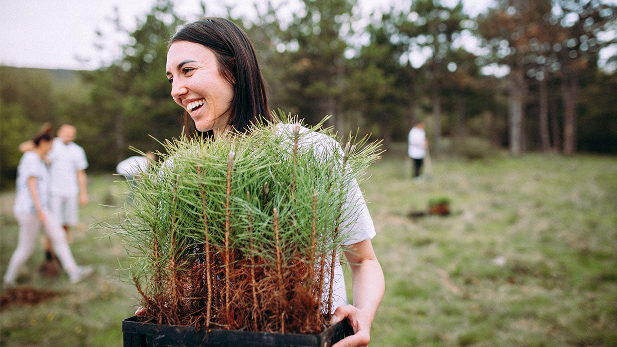 A woman holding a plant