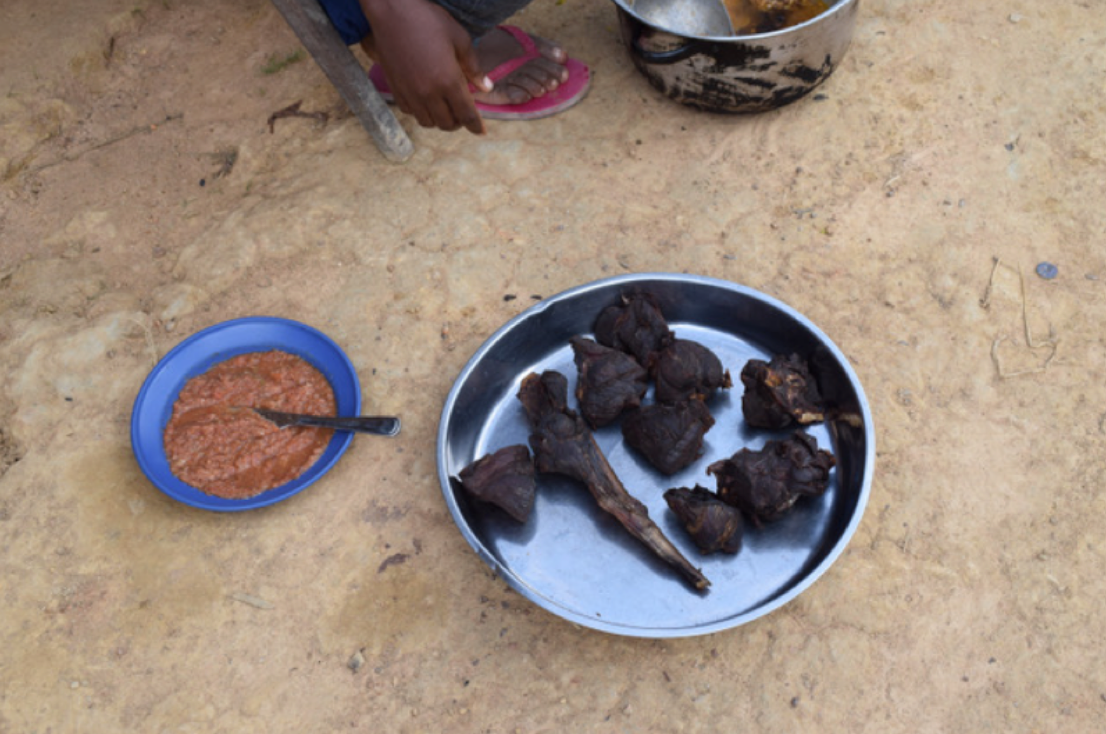 A woman prepares duiker meat with chili sauce in Cameroon. Photo: Stephanie Brittain