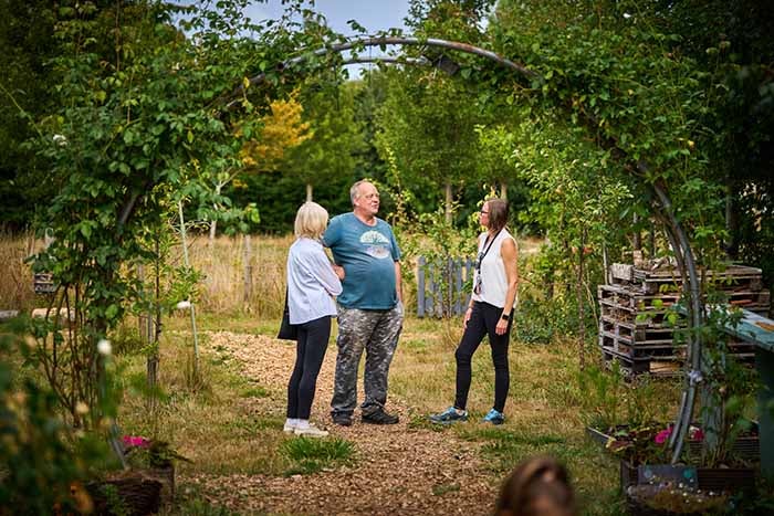 Michael Parker in the community garden speaking to colleagues from SNG