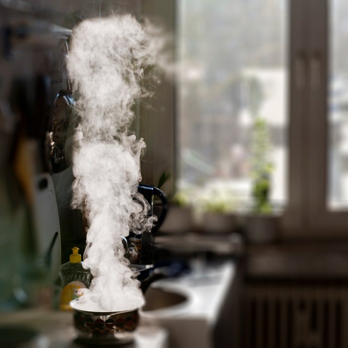 In the backlight, the sun shining through a window freed steam from a boiling pot