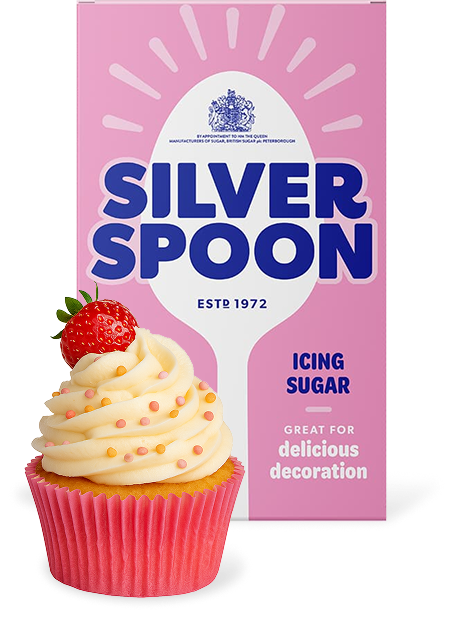 A pink pack of Silver Spoon icing sugar with a cupcake placed in front of it.