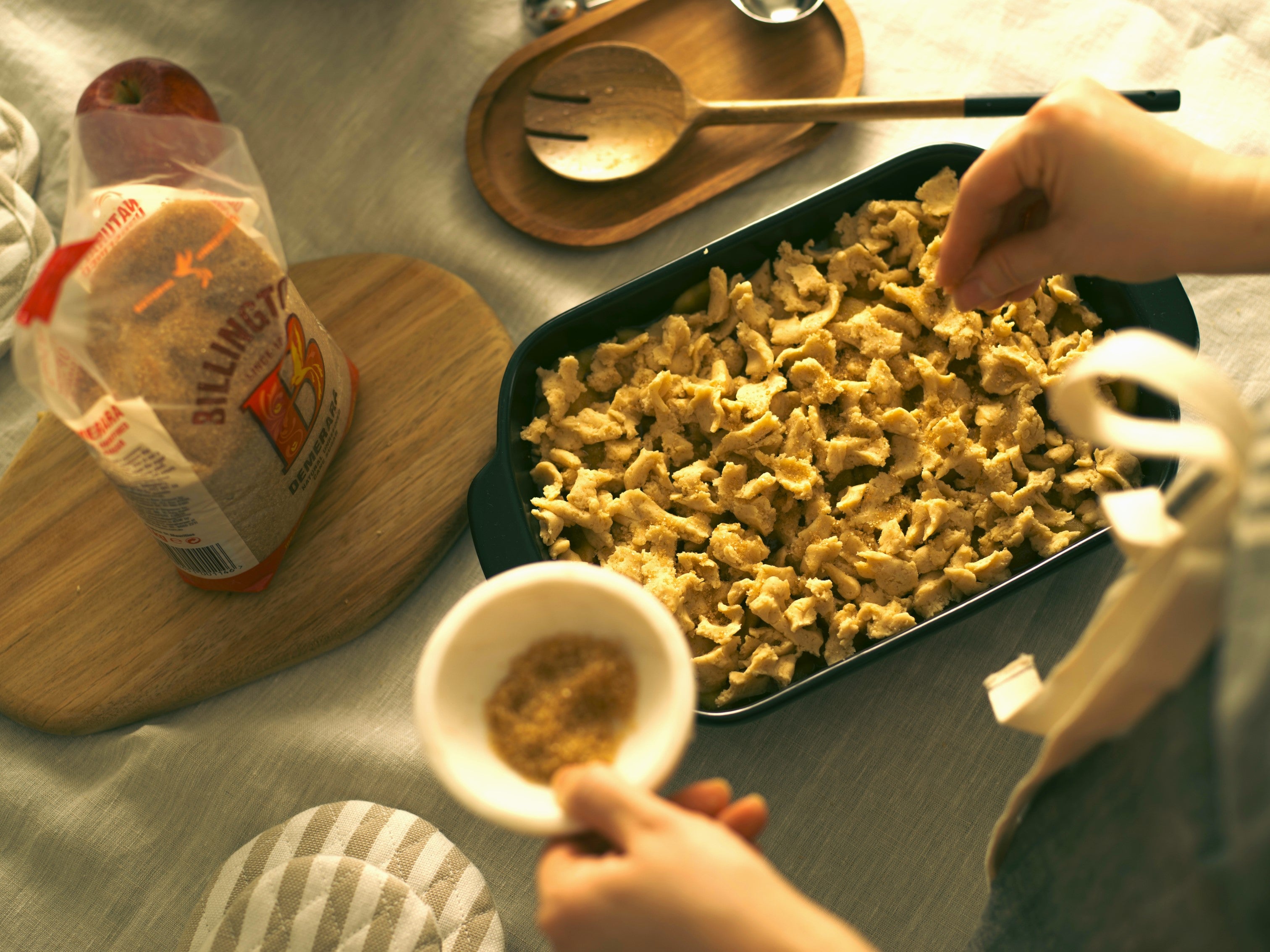 Adding a sweet, buttery crumble topping to Mary Berry's apple crumble recipe