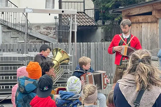 Die Schüler der GS Sexten musizieren mit den Referenten Michael und Christoph Hackhofer beim Abschluss des Projektes Musigkischtl XXL im April 2024.