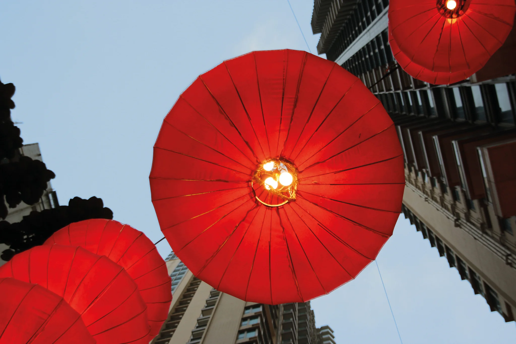 Red lanterns photographed from below in Hong Kong.
