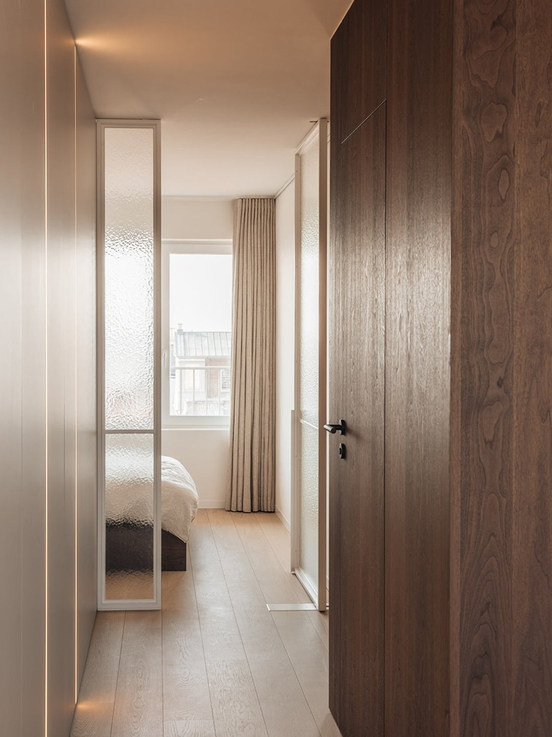 A room with a bed and a wood floor - hallway - bedroom - interior design - wood veneer