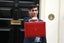 Chancellor Rishi Sunak holding the red briefcase outside No. 11 Downing Street 