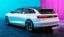 White Volkswagen ID.Space Vission estate rear-three quarter view in blue and pink light 
