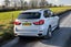 BMW X5 (2014-2018) Review: Exterior rear three quarter photo of the BMW X5 on the road