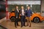 Guy Pigounakis (centre), commercial director, MG UK, receives the UK Car of the Year 2023 trophy from John Challen (left), director of the UK Car of the Year Awards, and Chris Evans (right), head of sales at HeyCar
