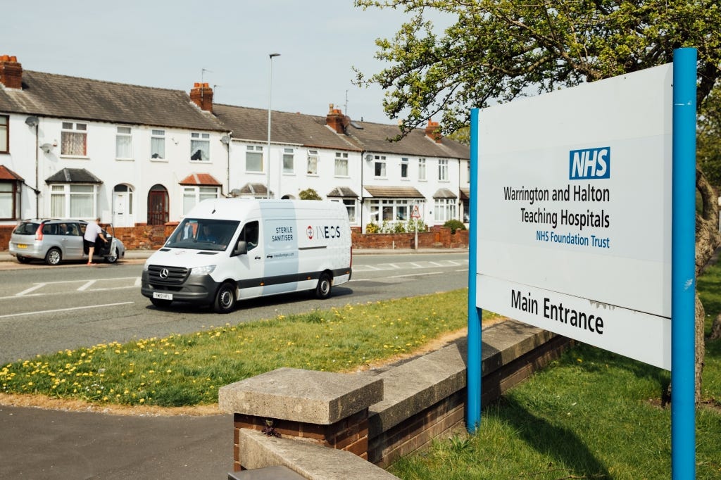 a photo of a sign outside of warrington and halton teaching hospitals