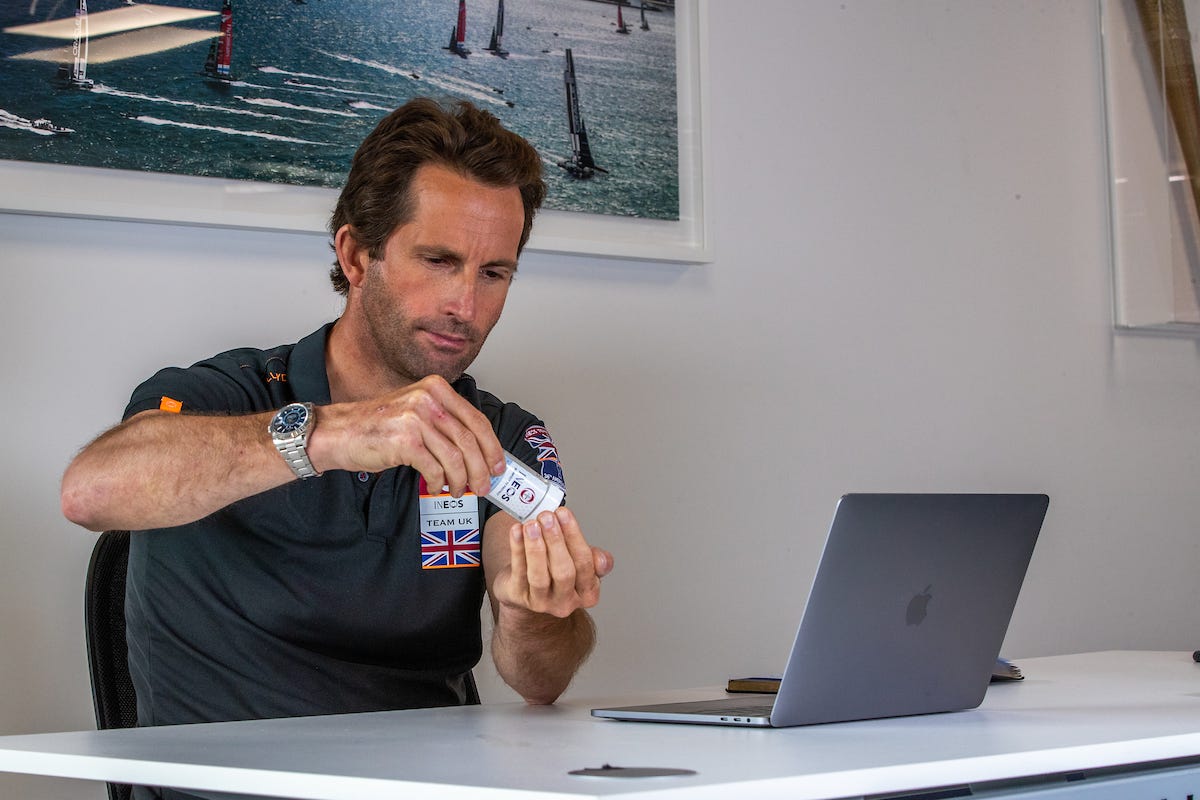 a man sat at a desk applying ineos hygienics hand sanitiser