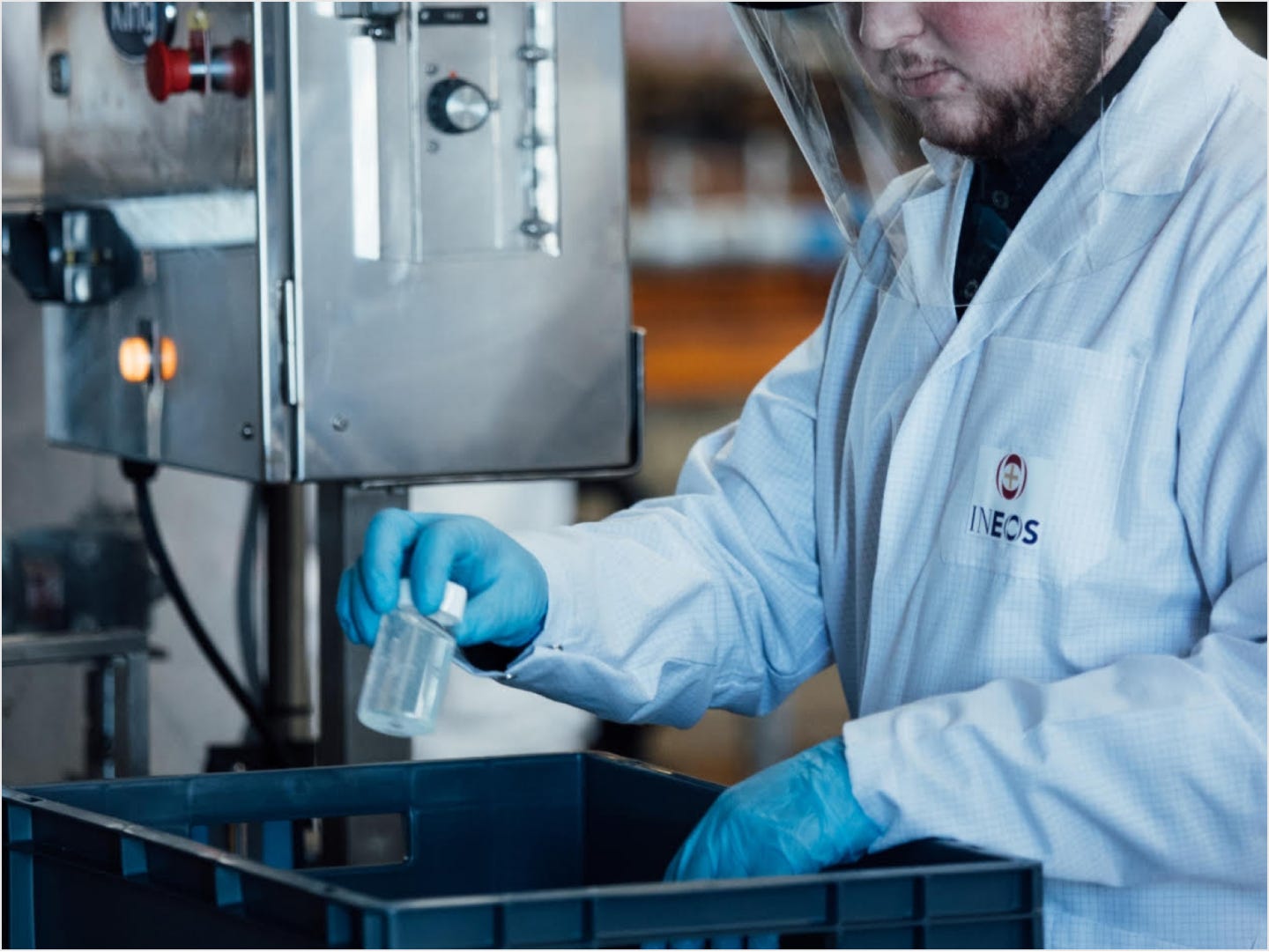 someone working in a lab wearing an ineos branded lab coat