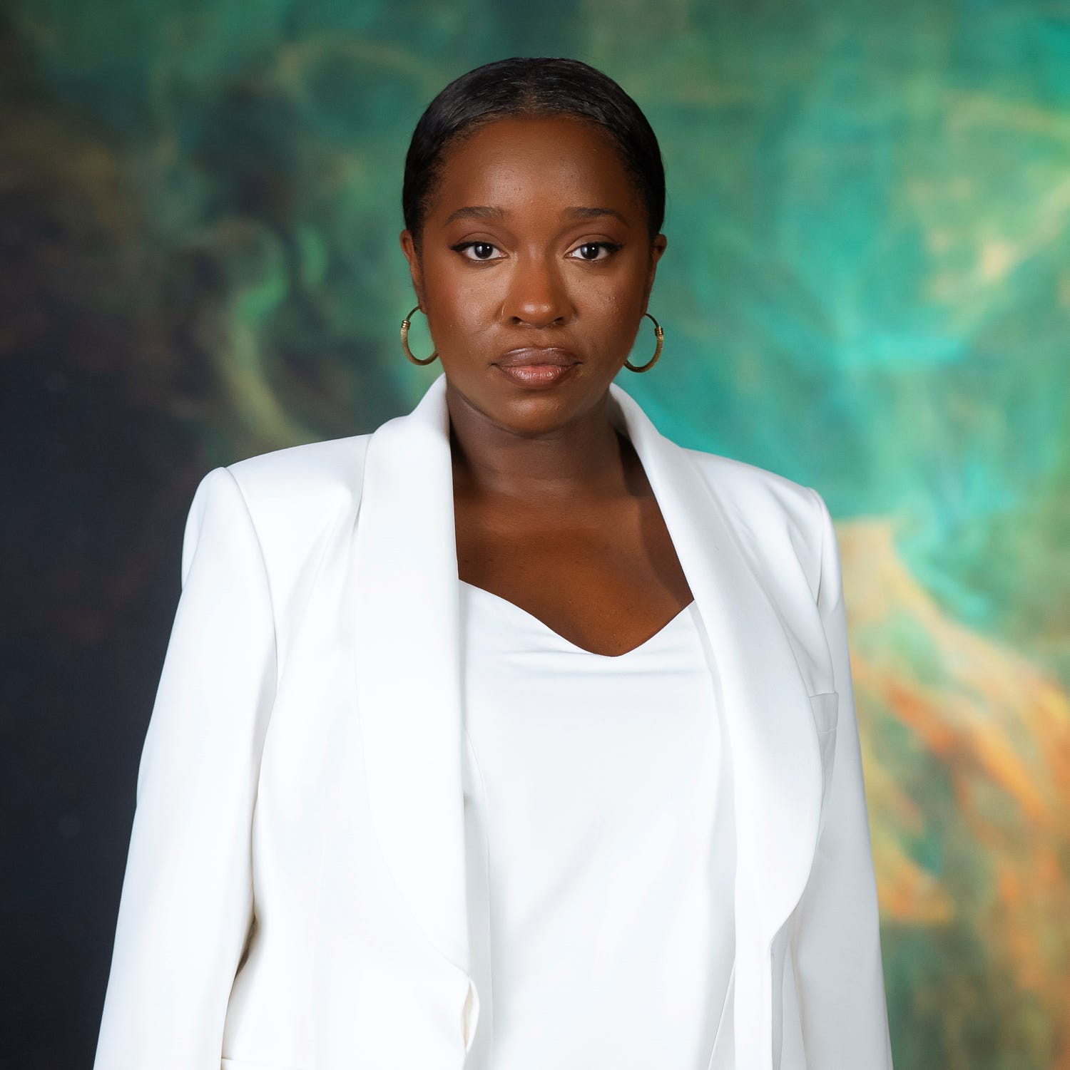 a photo of dr michaela in a white suit on a green and gold background