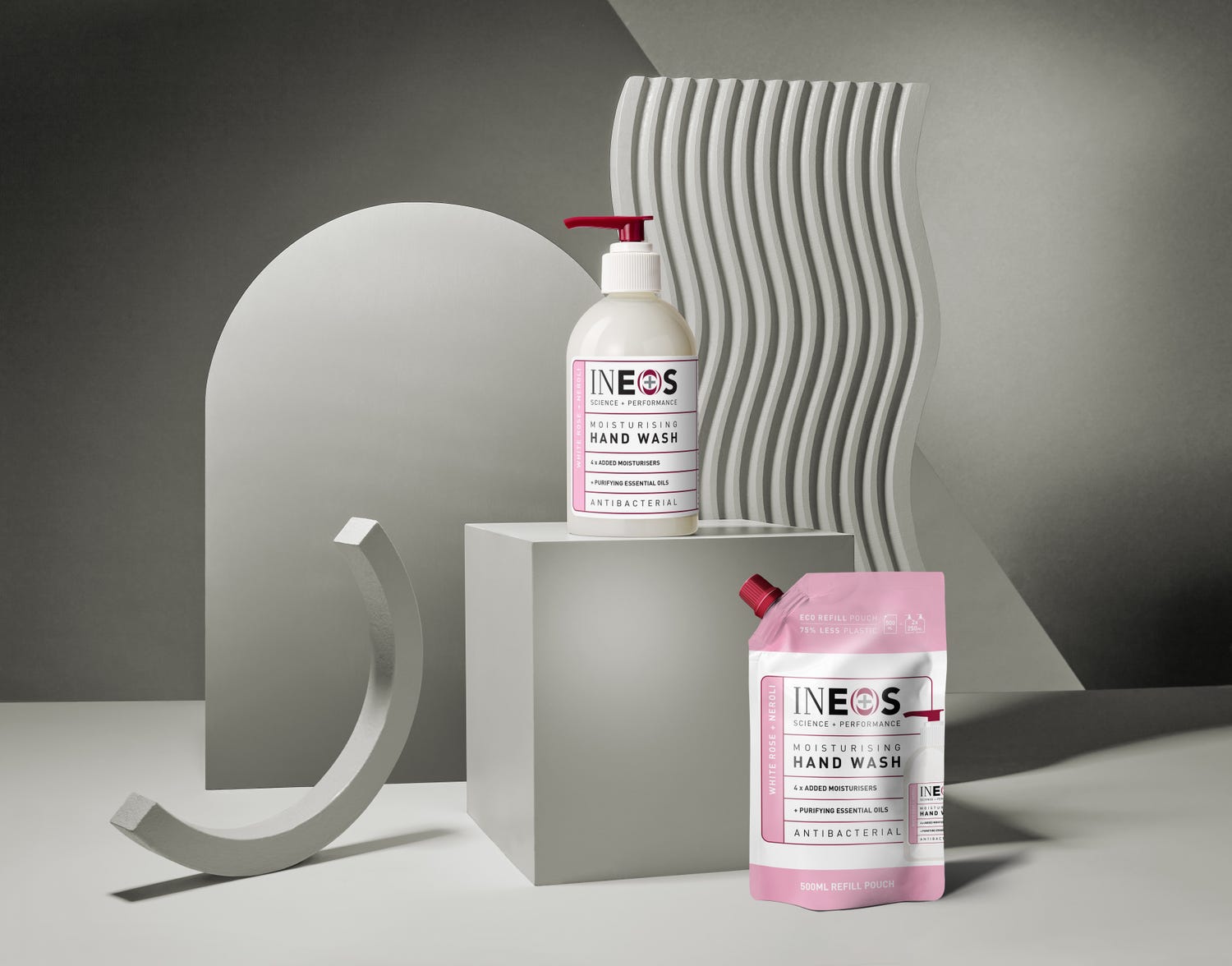a photo of ineos hygienics moisturising white rose and neroli hand wash on an abstract grey background