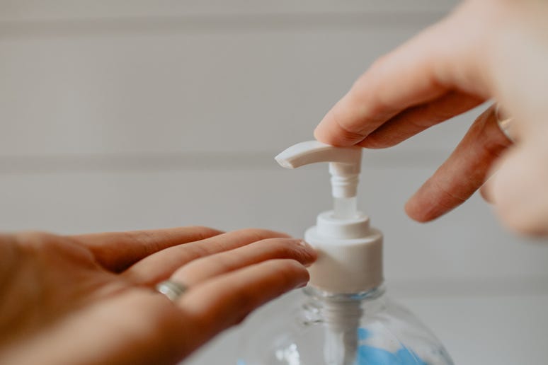 a photo of someone putting hand sanitiser on their hands