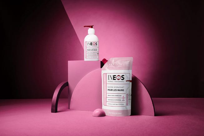 a photo of the french ineos hand wash and refill pack on a pink background