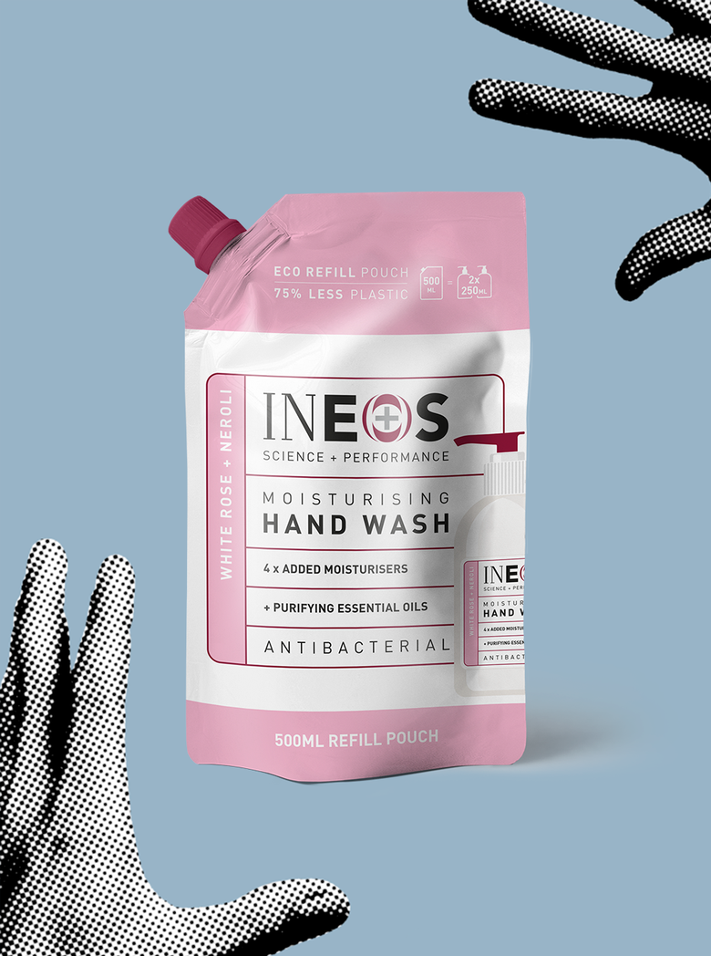 a photo of ineos hygienics hand wash refill on a blue background with hands reaching for it