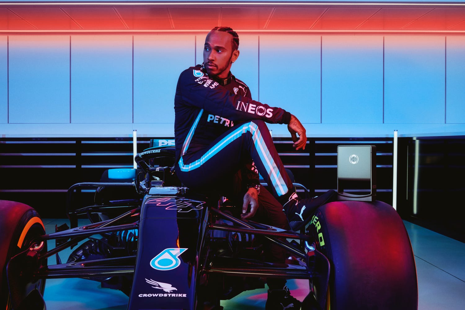 a photo of lewis hamilton sat on top of a formula one car