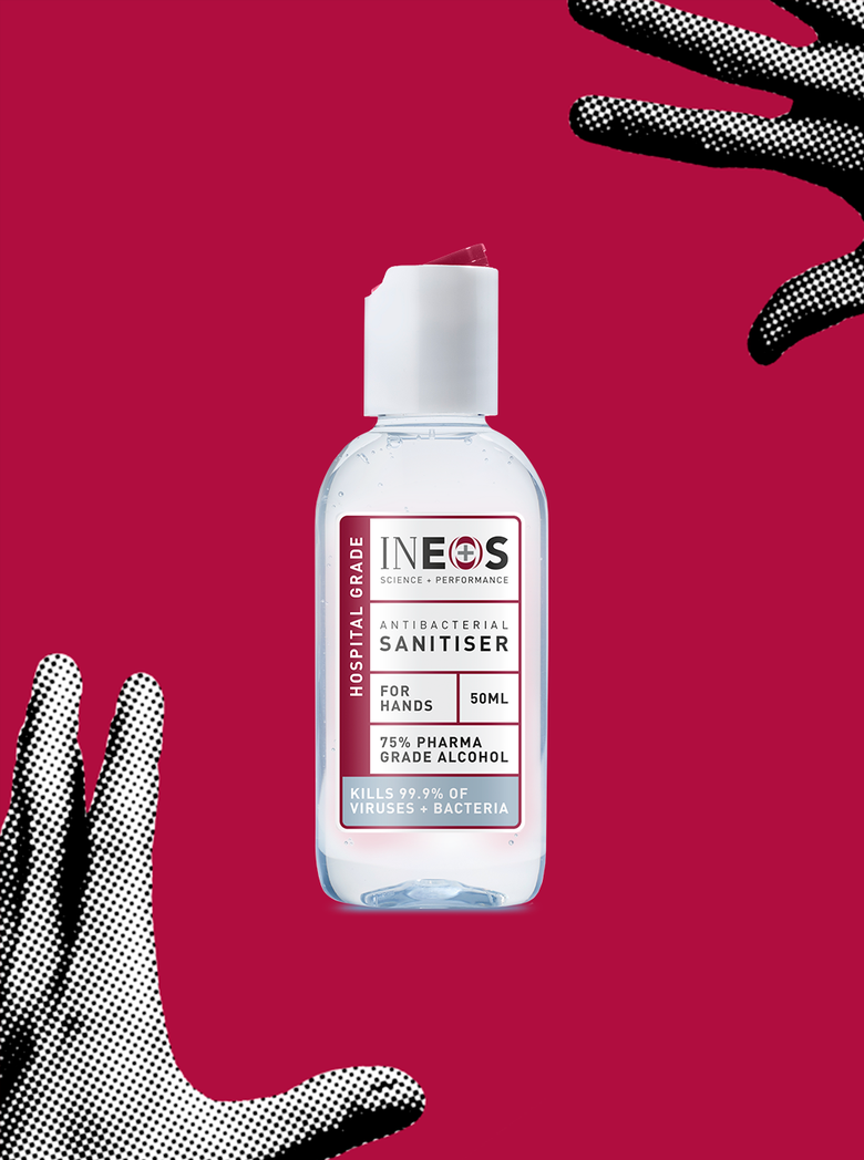 a photo of a travel-sized bottle of ineos hygienics hand sanitiser on a red background with hands reaching for it