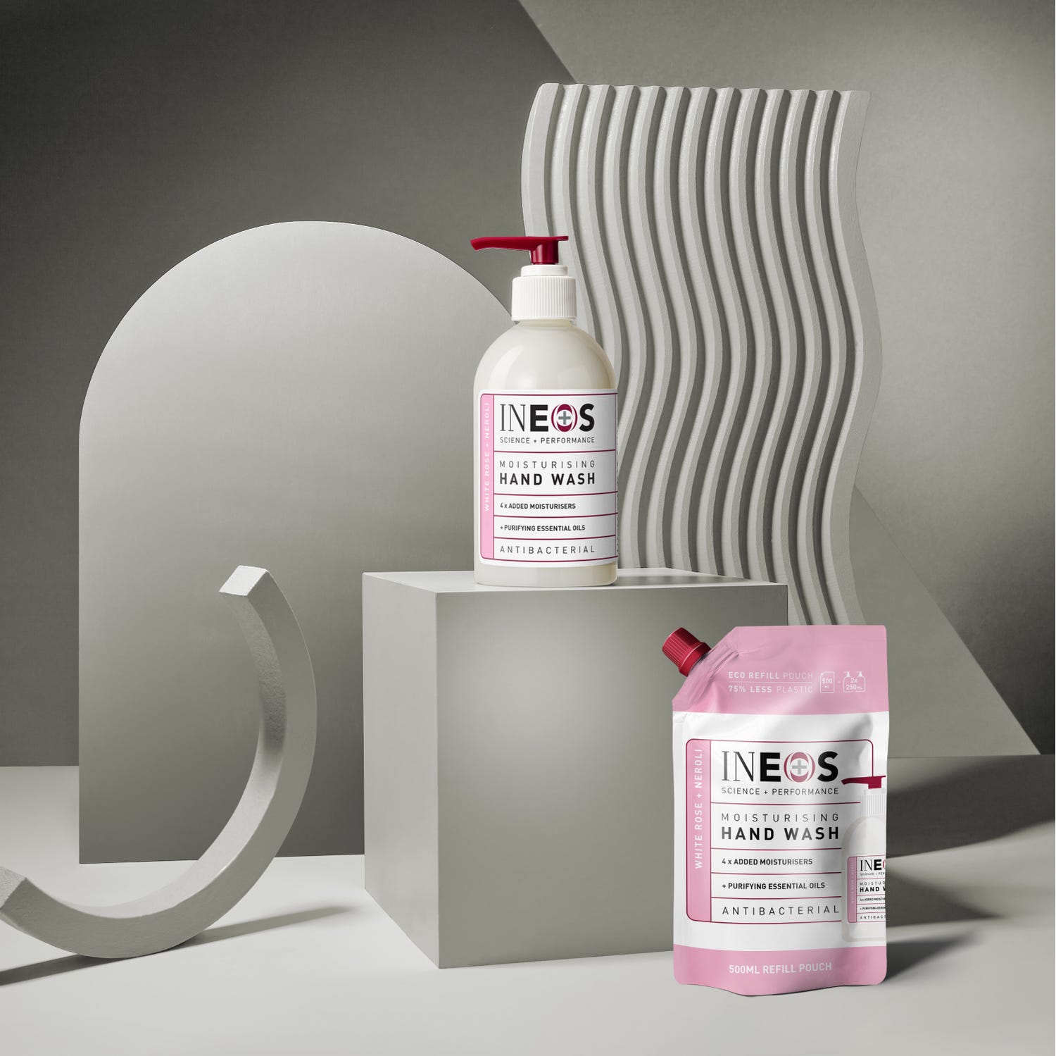 a photo of ineos hygienics moisturising white rose and neroli hand wash on an abstract grey background