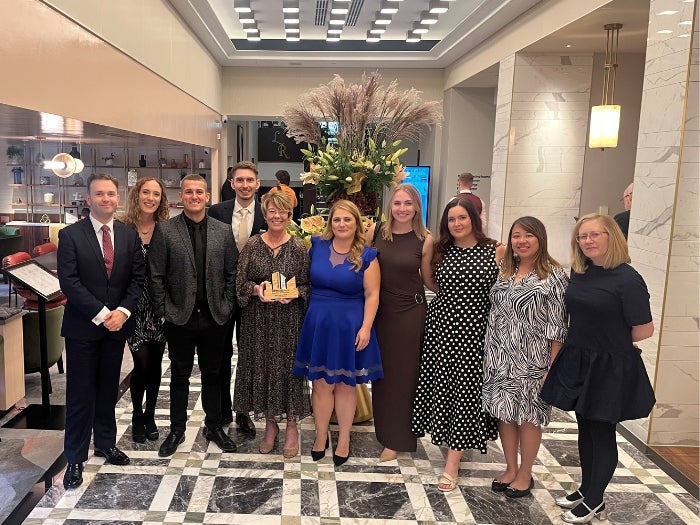 Group photo of SNG employees with the Highly Commended award for the Best Show Home category at the First Time Buyer Readers' Awards