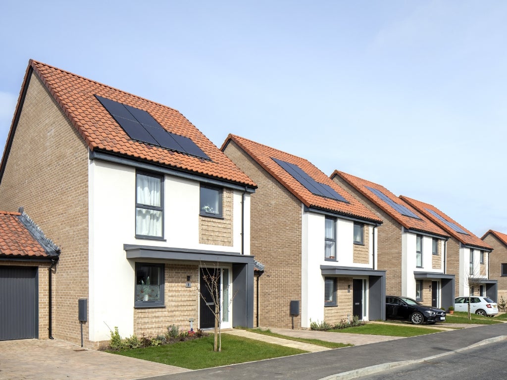 A row of new build homes with solar panels on their roofs at the Blackberry Hill development in Bristol