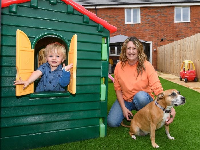 Vicki and her son play in their new garden 