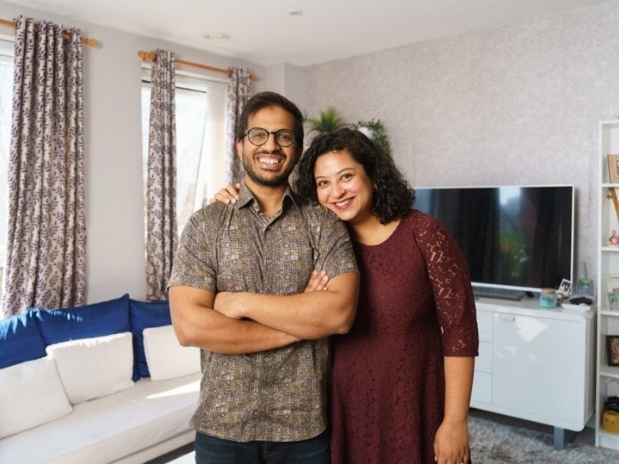 Anindya and Oishani pose for a picture in their living room.