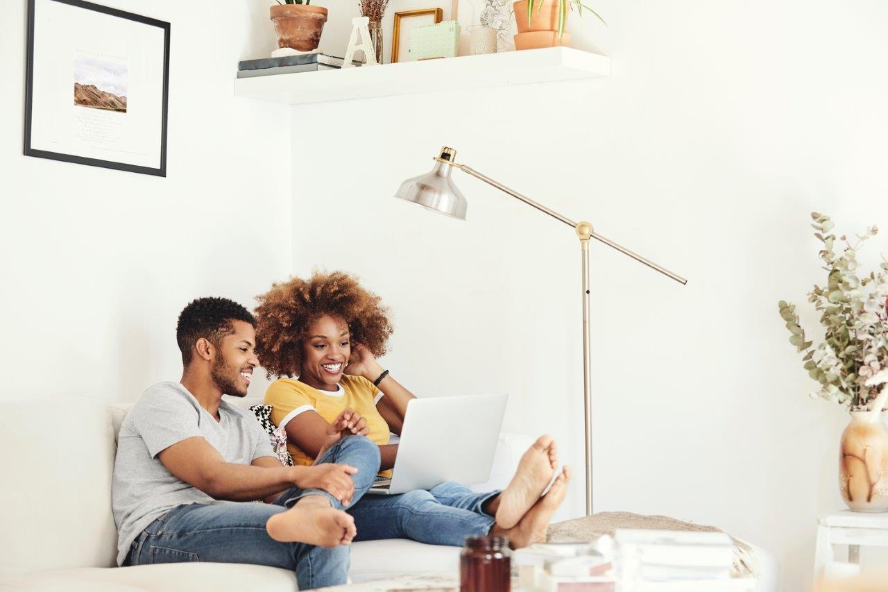 Stock image showing couple looking at laptop